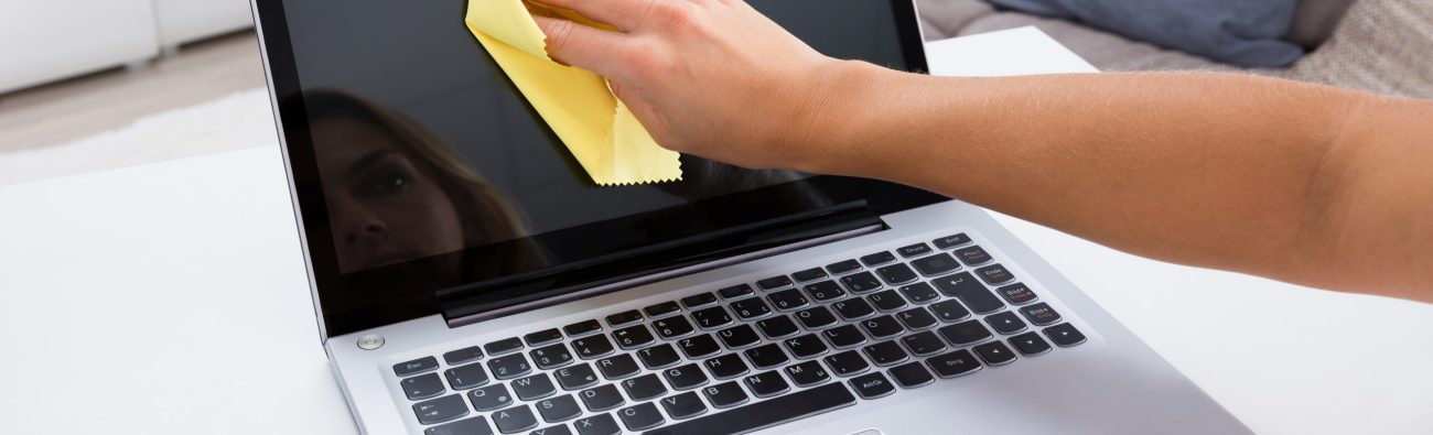 Close-up,Of,Woman,Hand,Cleaning,Laptop,Screen,With,Laptop,At