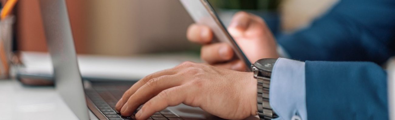 Close,Up.,Male,Businessman,Work,With,Phone,And,Laptop,In