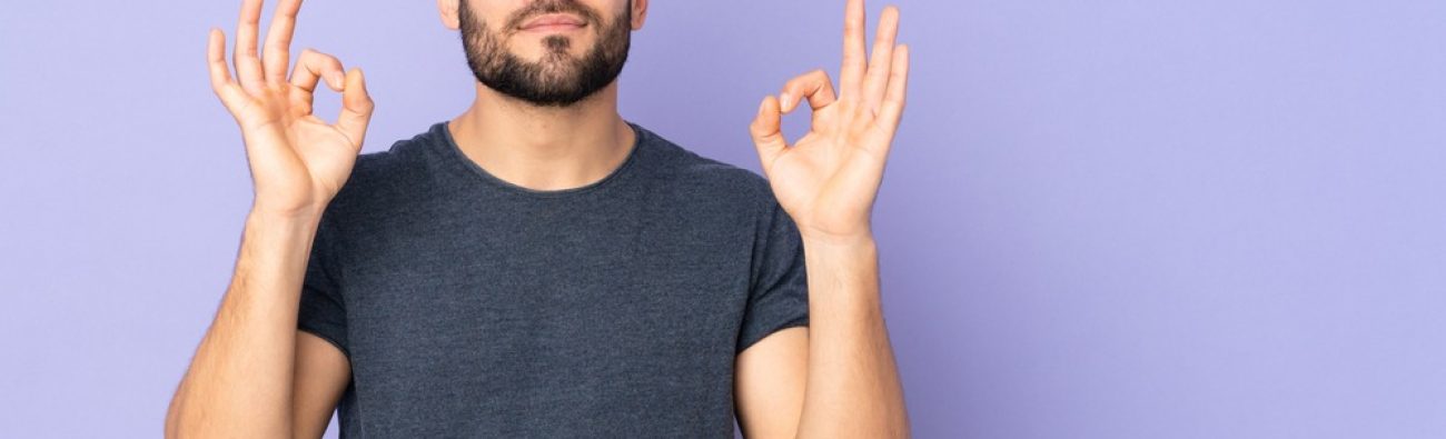 Caucasian,Handsome,Man,In,Zen,Pose,Over,Isolated,Purple,Background